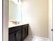 Clean bathroom with dark vanity and marble-tiled floors at 791 Pebble Beach Dr, Davenport, FL 33896