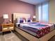 Bedroom with a queen-size bed and patterned bedding at 791 Pebble Beach Dr, Davenport, FL 33896
