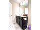 Bathroom with dark vanity, toilet and marble floor at 791 Pebble Beach Dr, Davenport, FL 33896