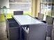 Patio furniture with a glass top table and wicker chairs at 791 Pebble Beach Dr, Davenport, FL 33896
