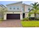 Modern two-story house with a dark brown garage door at 791 Pebble Beach Dr, Davenport, FL 33896