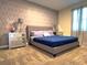 Spacious bedroom featuring a comfortable bed and geometric wallpaper at 791 Pebble Beach Dr, Davenport, FL 33896