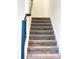 Carpeted staircase with dark wood railing at 791 Pebble Beach Dr, Davenport, FL 33896