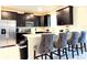 Modern kitchen with stainless steel appliances and an island with seating at 791 Pebble Beach Dr, Davenport, FL 33896