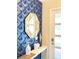 Stylish entryway with geometric wallpaper and a unique mirror at 791 Pebble Beach Dr, Davenport, FL 33896
