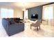 Spacious living room with a large TV and comfortable seating at 791 Pebble Beach Dr, Davenport, FL 33896