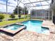 Private screened pool and spa with plenty of space for lounging and entertaining at 791 Pebble Beach Dr, Davenport, FL 33896
