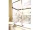 Updated bathroom with a large walk-in shower and marble tile at 791 Pebble Beach Dr, Davenport, FL 33896
