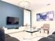 Modern living room with large TV, comfortable seating, and art at 791 Pebble Beach Dr, Davenport, FL 33896