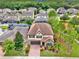 Aerial view of two story house with landscaped yard, and community in background at 5232 Villa Rosa Ave, St Cloud, FL 34771