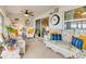 Inviting screened porch with wicker furniture, decorative accents, and natural light at 5428 Tessin Trl, Saint Cloud, FL 34771