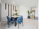 Modern dining area with stylish blue chairs and marble-top table at 2118 Gentle Rain Dr, Edgewater, FL 32141