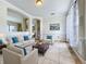 Bright living room with beige sofas, coffee table, and tiled floors at 1250 Shorecrest Cir, Clermont, FL 34711