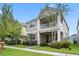 Two-story house with a front porch and a well-maintained lawn at 8831 Ribault Ave, Orlando, FL 32832