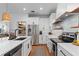 Clean and bright kitchen featuring white cabinets, stainless steel appliances, and a large island at 8831 Ribault Ave, Orlando, FL 32832