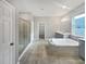 Spa-like bathroom with soaking tub, walk-in shower, and double vanity at 5408 Manchester Dr, St Cloud, FL 34771