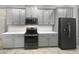 Modern kitchen with gray cabinets and stainless steel appliances at 5408 Manchester Dr, St Cloud, FL 34771