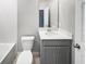 Modern bathroom with gray vanity and a tub at 5408 Manchester Dr, St Cloud, FL 34771