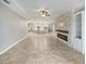 Open concept living room with a stone fireplace and kitchen access at 5408 Manchester Dr, St Cloud, FL 34771