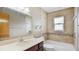 Bathroom with tub, vanity, and tiled flooring at 3472 Country Walk Dr, Port Orange, FL 32129