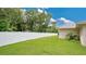 Large backyard with a white vinyl fence and lush green grass at 3472 Country Walk Dr, Port Orange, FL 32129