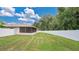 Spacious backyard with screened patio and grassy area at 3472 Country Walk Dr, Port Orange, FL 32129