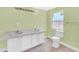Bathroom with double vanity and white cabinets at 5351 E Johnson Ave, Haines City, FL 33844