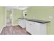 Clean kitchenette with white cabinets and granite counters at 5351 E Johnson Ave, Haines City, FL 33844