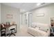 Upstairs hallway with seating area and doors to bedrooms at 1820 Holden Ridge Ln, Clermont, FL 34715