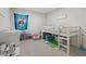 A bedroom with a loft bed, toys, and ample storage at 1820 Holden Ridge Ln, Clermont, FL 34715