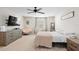 Main bedroom with large bed, dresser, and TV at 1820 Holden Ridge Ln, Clermont, FL 34715