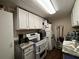 White kitchen cabinets, granite countertops, and stainless steel appliances at 1117 E Hubbard Ave, Deland, FL 32724