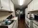 White kitchen cabinets, granite countertops, and stainless steel appliances at 1117 E Hubbard Ave, Deland, FL 32724