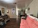 Living room with dark hardwood floors and a coral couch at 1117 E Hubbard Ave, Deland, FL 32724
