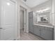 Bathroom with gray cabinets, granite countertop, and a view of another room at 5440 Nw 34Th St, Ocala, FL 34482