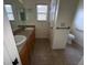 Bathroom with dual sinks, a toilet, and a shower/tub combo at 1166 Johnston Path, The Villages, FL 32162