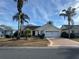 House exterior with a two-car garage and a landscaped front yard at 1166 Johnston Path, The Villages, FL 32162