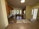 Kitchen with light wood cabinets, a double sink, and a view of the dining area at 1166 Johnston Path, The Villages, FL 32162