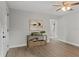 Living room with wood-look floors, a console table, and access to the bathroom at 1321 Cloverlawn Ave, Orlando, FL 32806