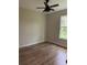 Spacious bedroom with wood-look flooring and ceiling fan at 1420 Lake Harney Rd, Geneva, FL 32732