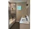 Bathroom with double vanity, bathtub, and window at 1420 Lake Harney Rd, Geneva, FL 32732