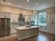 Modern kitchen with white cabinets, quartz countertops, and stainless steel appliances at 1420 Lake Harney Rd, Geneva, FL 32732