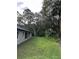 Private backyard with grassy area and mature trees at 1420 Lake Harney Rd, Geneva, FL 32732