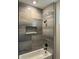 Shower with grey tile and built-in shelf at 1420 Lake Harney Rd, Geneva, FL 32732