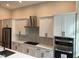 White shaker cabinets, quartz countertops and stainless steel appliances in a modern kitchen at 1420 Lake Harney Rd, Geneva, FL 32732