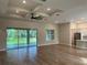 Open living room with hardwood floors and sliding glass doors to backyard at 1420 Lake Harney Rd, Geneva, FL 32732
