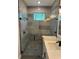 Walk-in shower with grey tile and hexagon floor at 1420 Lake Harney Rd, Geneva, FL 32732