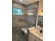 Bathroom with shower, double vanity, and window at 1420 Lake Harney Rd, Geneva, FL 32732
