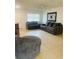 Living room with gray couches, a ceiling fan, and tile flooring at 2677 Tansboro Dr, Deltona, FL 32725