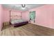 Spacious bedroom with a large four-poster bed and wood-look flooring at 108 Clear Lake Cir, Sanford, FL 32773